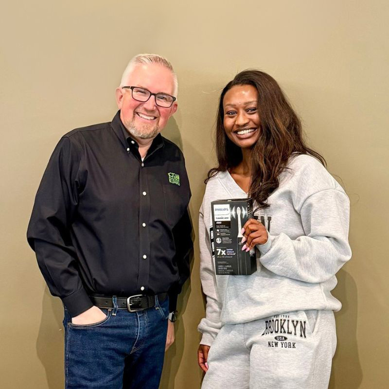 Adult-Orthodontic-Treatment-Denver-Colorado Adult orthodontic patient smiling with orthodontist at Kohrs Orthodontics in Aurora CO after braces or Invisalign treatment