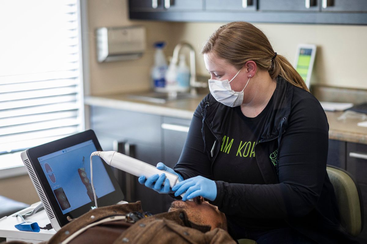 exper-itero-scanning-at-kohrs-orthodontics iTero digital scanner used for clear aligner treatment at Kohrs Orthodontics in Aurora, Bennett, and Strasburg, CO, providing expert, top-rated orthodontic care