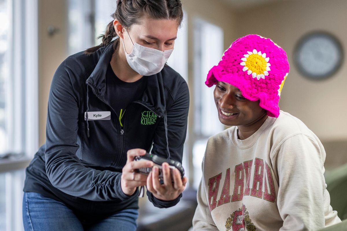 expert-orthodontic-strasburg-things-to-do Dental hygienist talking with patient wearing pink crochet hat at Kohrs Orthodontics Strasburg, Colorado offering expert, top-rated orthodontic care