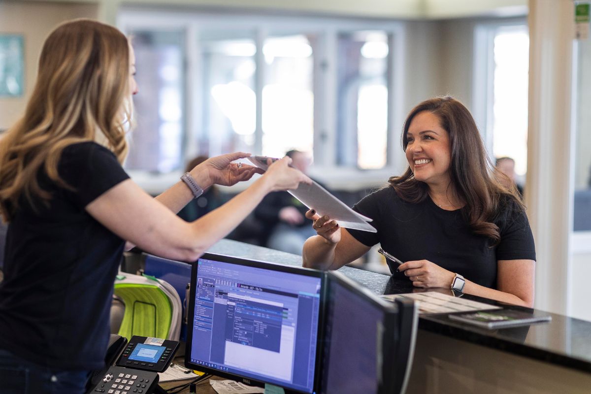 expert-orthodontic-treatment-options-denver-co Friendly front desk team assisting patients at Kohrs Orthodontics in Aurora, Bennett, and Strasburg, CO, providing expert, top-rated orthodontic services