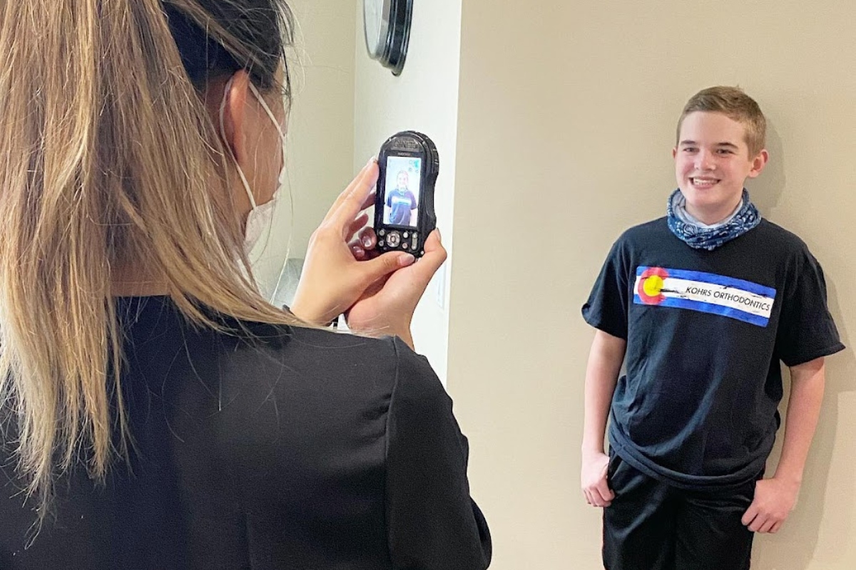 Smiling child showing straight teeth after braces at Kohrs Orthodontics, top-rated orthodontist near Heather Ridge