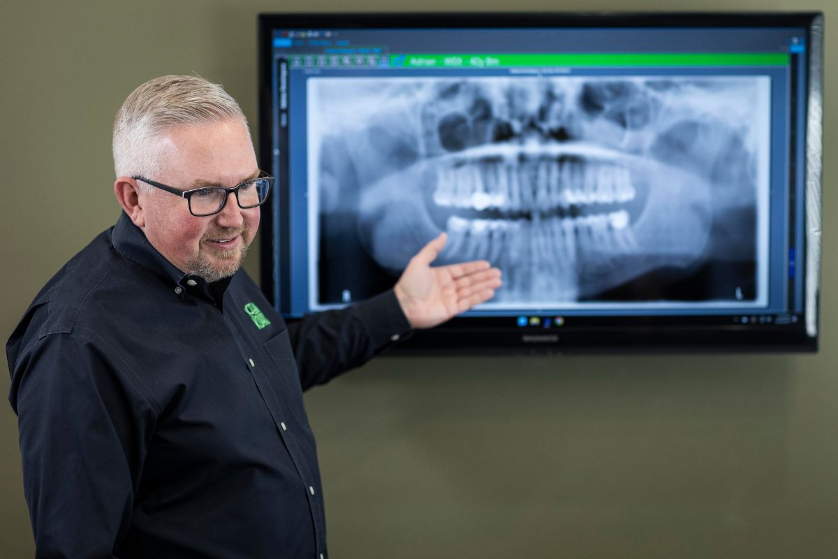 expert-surgical-orthodontic-treatment-denver-co Orthodontic specialist reviewing X-ray for surgical orthodontic treatment at Kohrs Orthodontics in Aurora, Bennett, Strasburg, Colorado