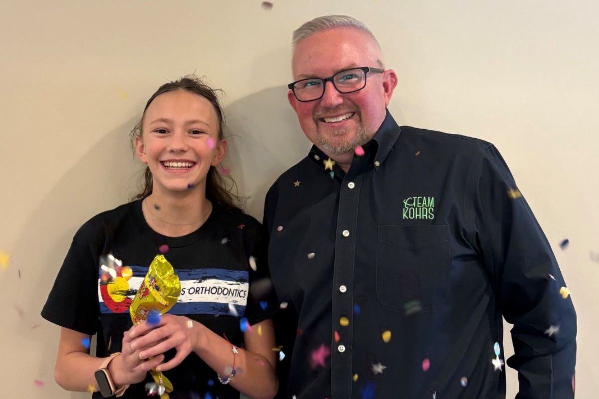 five-start-reviews-orthodontic-practice Happy braces patient celebrating orthodontic treatment success at Kohrs Orthodontics in Aurora, Bennett, and Strasburg, CO with expert, top-rated orthodontic care