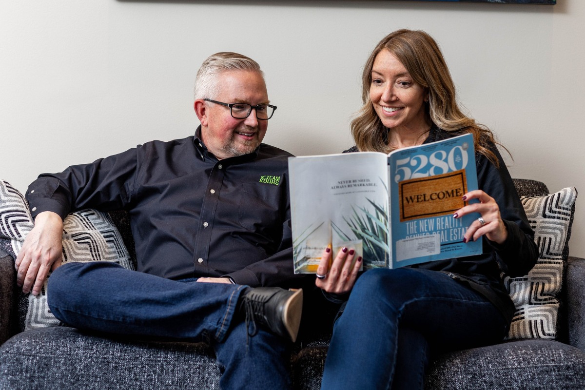 Kohrs Orthodontics team members reviewing patient information in a comfortable waiting area at a top-rated orthodontic office serving Aurora, Bennett, and Strasburg, Colorado