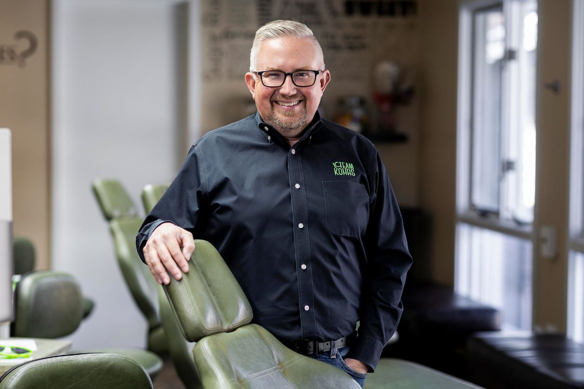 orthodontics-strasburg-dr-kohrs-top-rated-care Dr. Kohrs leaning against a green orthodontic chair at Kohrs Orthodontics Strasburg, Colorado providing expert, top-rated orthodontic care