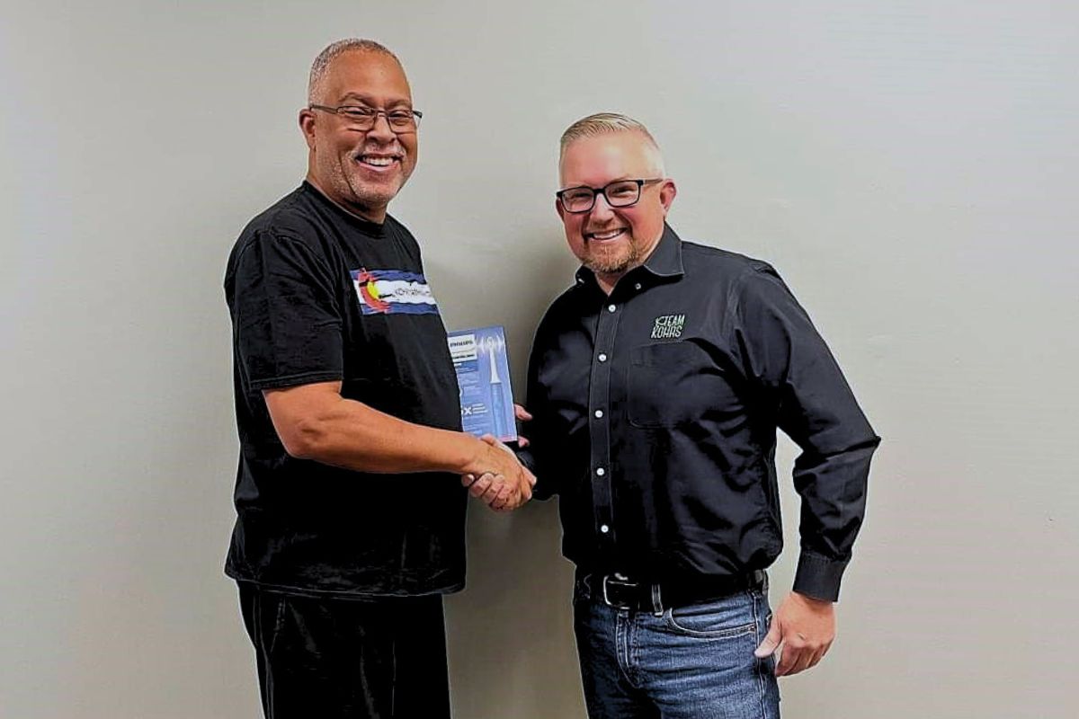 Adult orthodontic patient celebrating treatment progress at Kohrs Orthodontics in Aurora, Bennett, and Strasburg, CO, with a top-rated orthodontic specialist