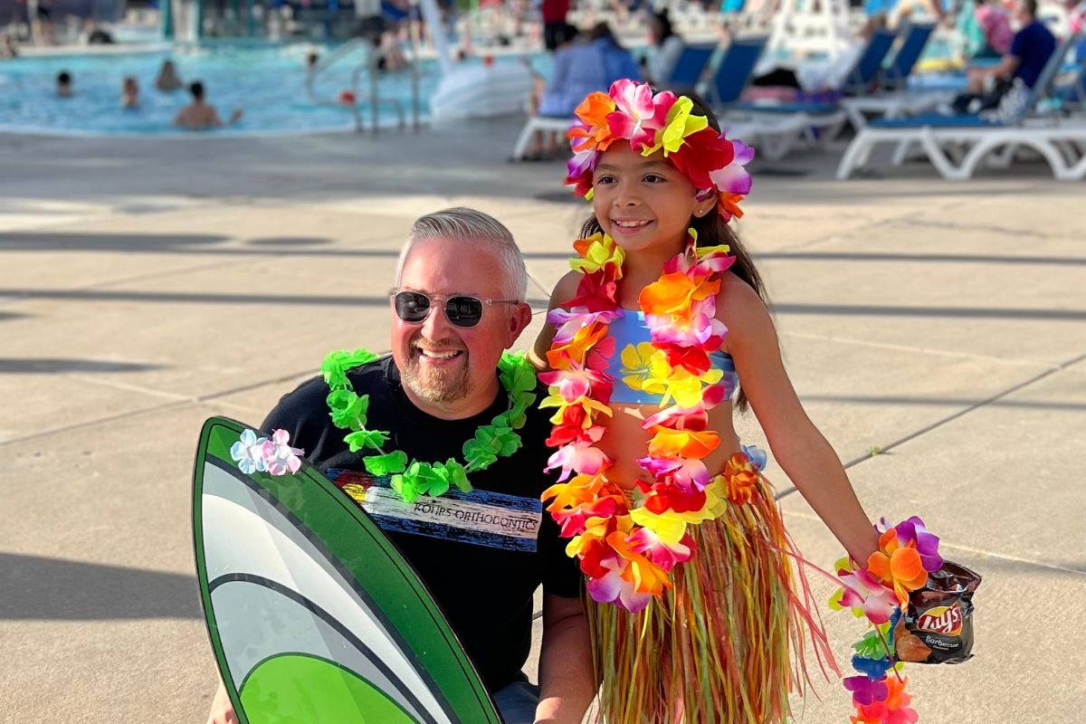 top-rated-orthodontist-metro-denver Kohrs Orthodontics team member celebrating with a young patient at a community event in Aurora, Bennett, and Strasburg, CO, showcasing top-rated, family-friendly orthodontic care