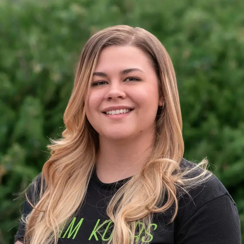 Katlynn at kohrs orthodontics smiling in outdoor team portrait showcasing orthodontic staff