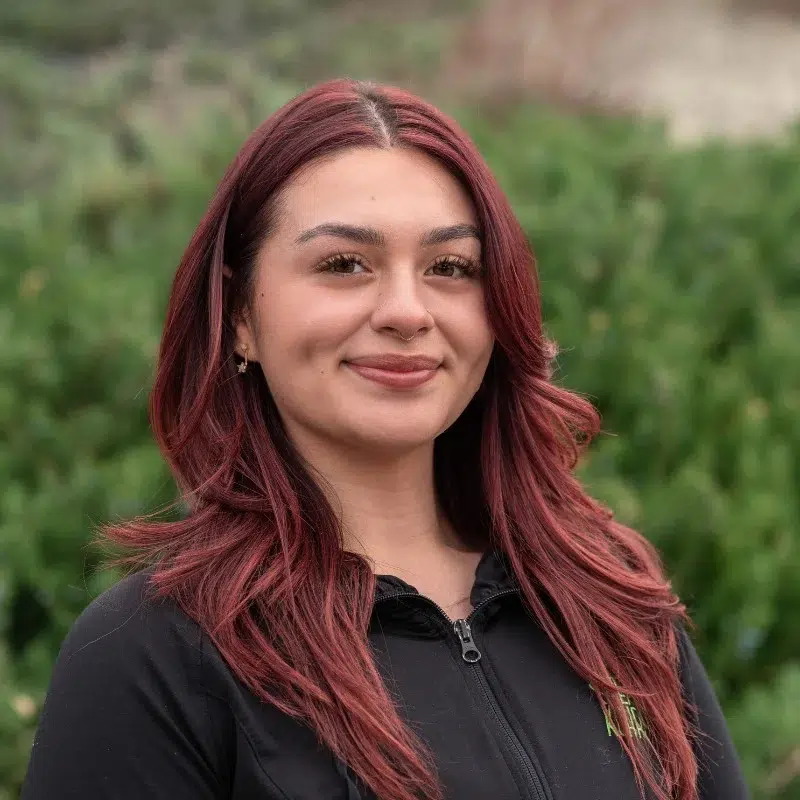 Kohrs-orthodontics-team-headshots-selena-clinical-assistant Selena at kohrs orthodontics team member portrait outdoors with friendly smile in orthodontic office setting