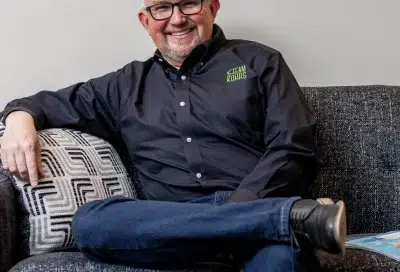 Dr. Kohrs named a topdentist by 5280 magazine for 19 years 3 Dr. Kohrs smiling and sitting on a couch, representing topdentist award