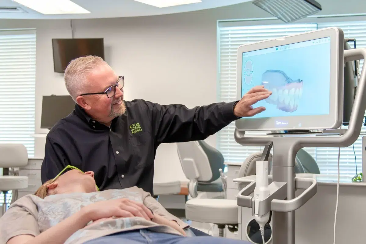 Kohrs-orthodontics-clear-braces-scan Expert orthodontist reviewing a digital clear braces scan at kohrs orthodontics in aurora, bennett, and strasburg, co, using advanced technology for top-rated orthodontic care