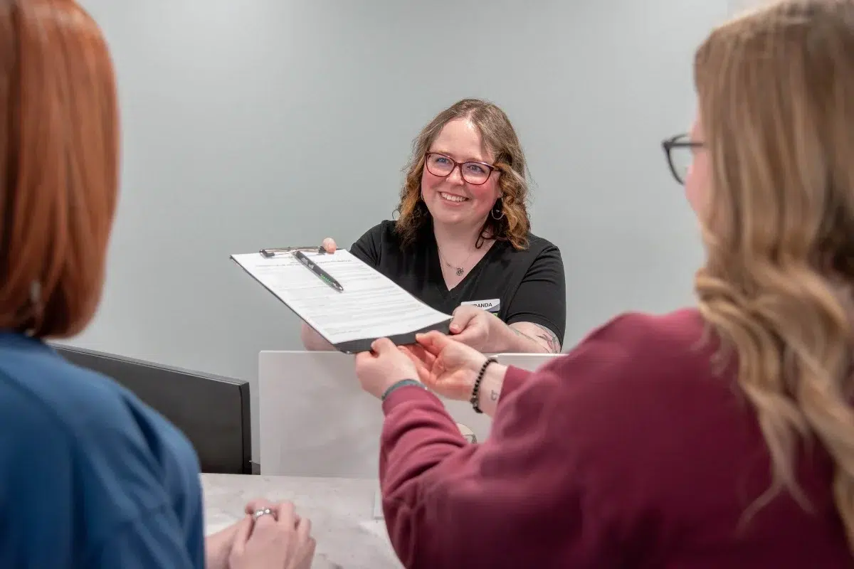 Kohrs-orthodontics-frequently-asked-questions Kohrs orthodontics team member answering clear braces questions in aurora, bennett, and strasburg, co, providing expert, top-rated orthodontic care in metro denver