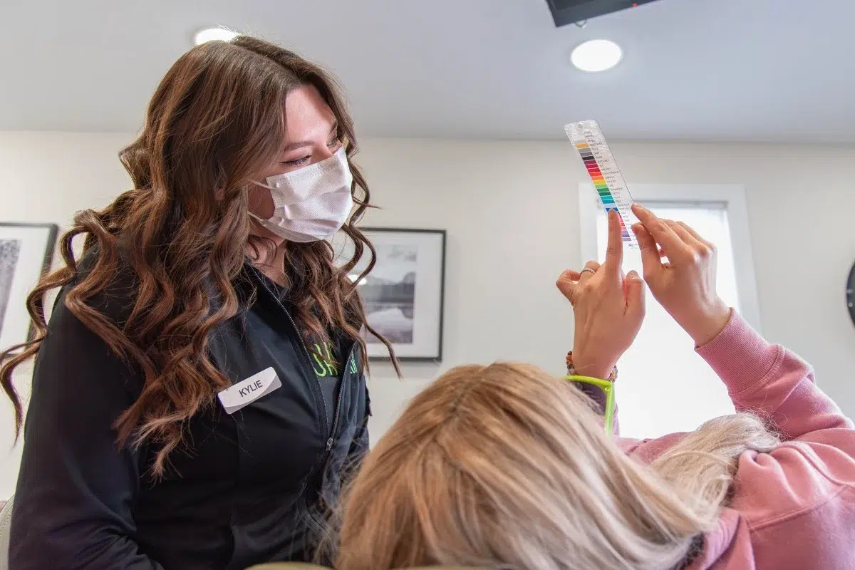 Kohrs-orthodontics-orthodontics-near-meadow-hills Kohrs orthodontics team member helping a patient choose braces colors in aurora, bennett, and strasburg, co, with expert, top-rated orthodontic care near meadow hills