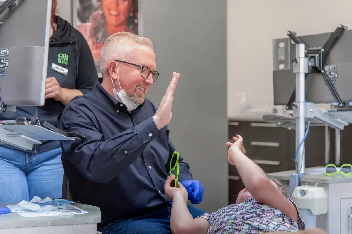 Kohrs-orthodontics-patient-stories Kohrs orthodontics patient giving a high five during braces and clear braces treatment in aurora, bennett, and strasburg, co, with expert, top-rated orthodontic care