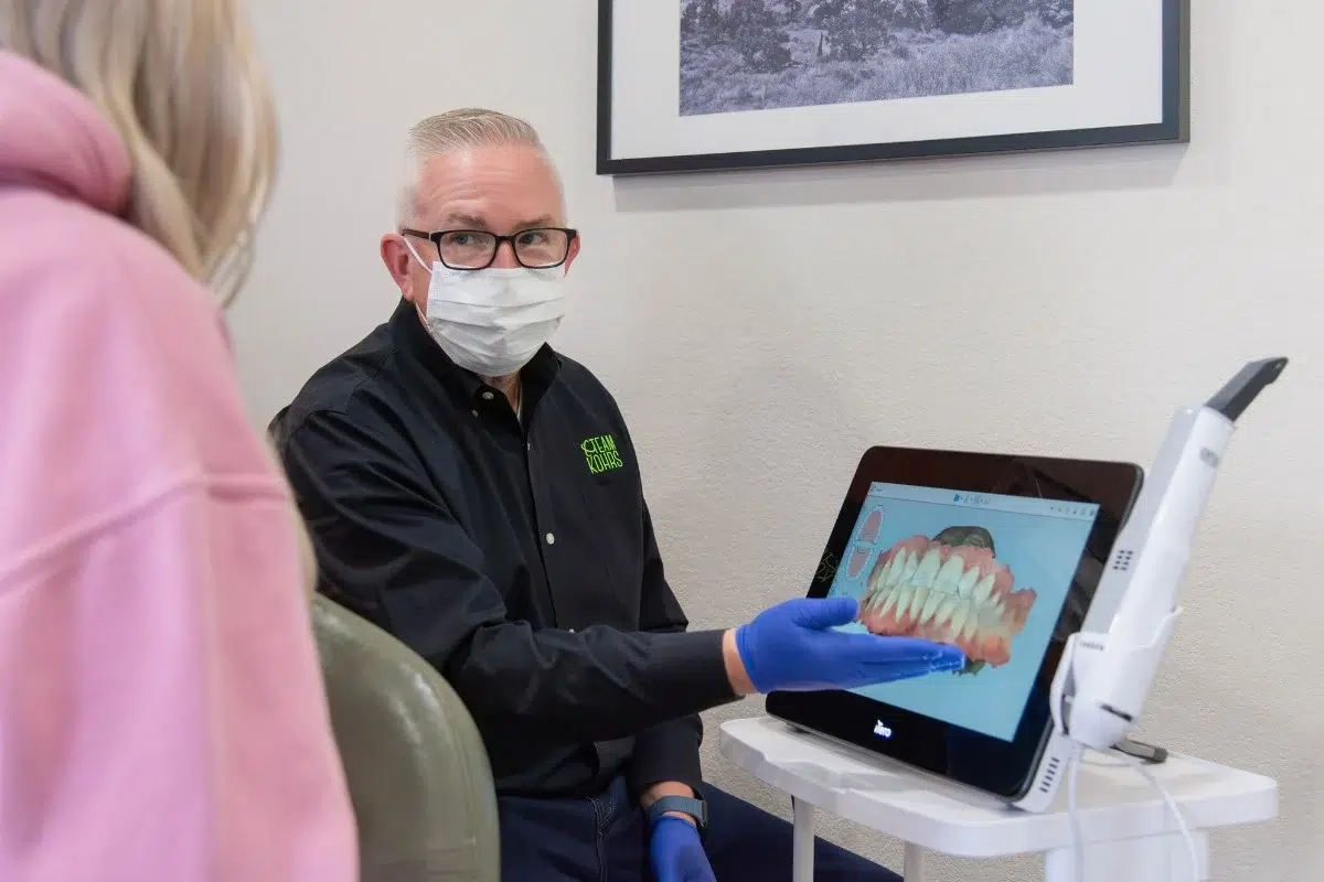 Kohrs-orthodontics-the-dam-orthodontics Expert orthodontist reviewing an itero digital scan for clear braces and clear aligner treatment at kohrs orthodontics in aurora, bennett, and strasburg, co