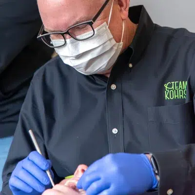 How dr. Kohrs builds your orthodontic treatment plan 3 Dr. Kohrs working on a patient's teeth, representing orthodontic treatment plan